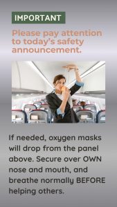Cabin crew on a plane demonstrating how to fit your safety mask